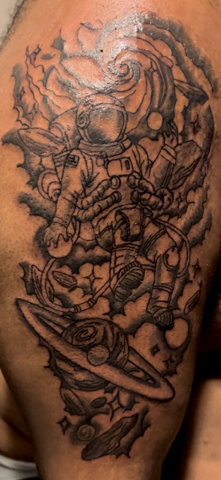 Astronaut and planets illustrative black and grey sleeve tattoo