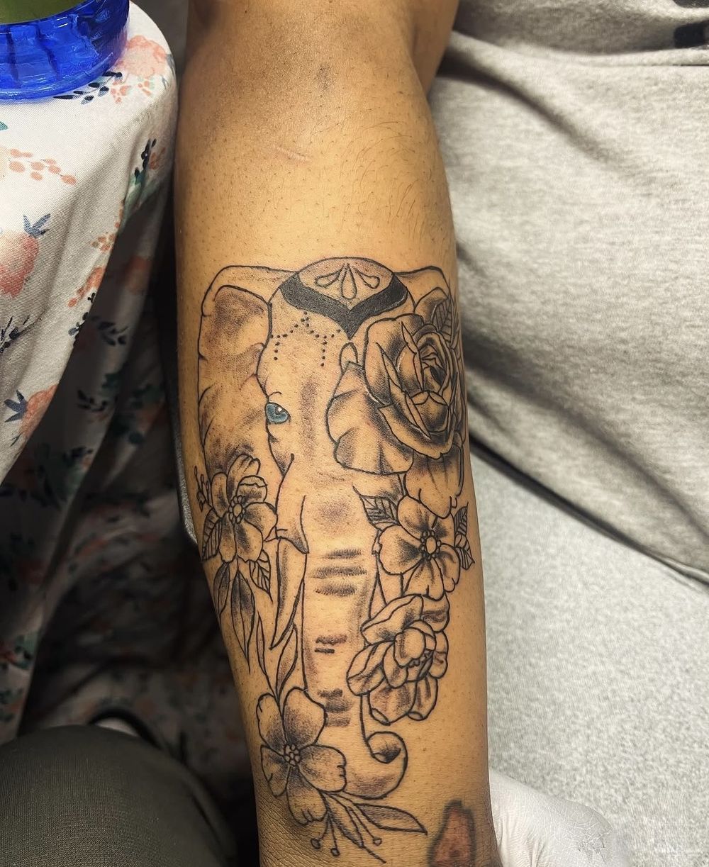 Elephant with rose and floral fine line forearm tattoo