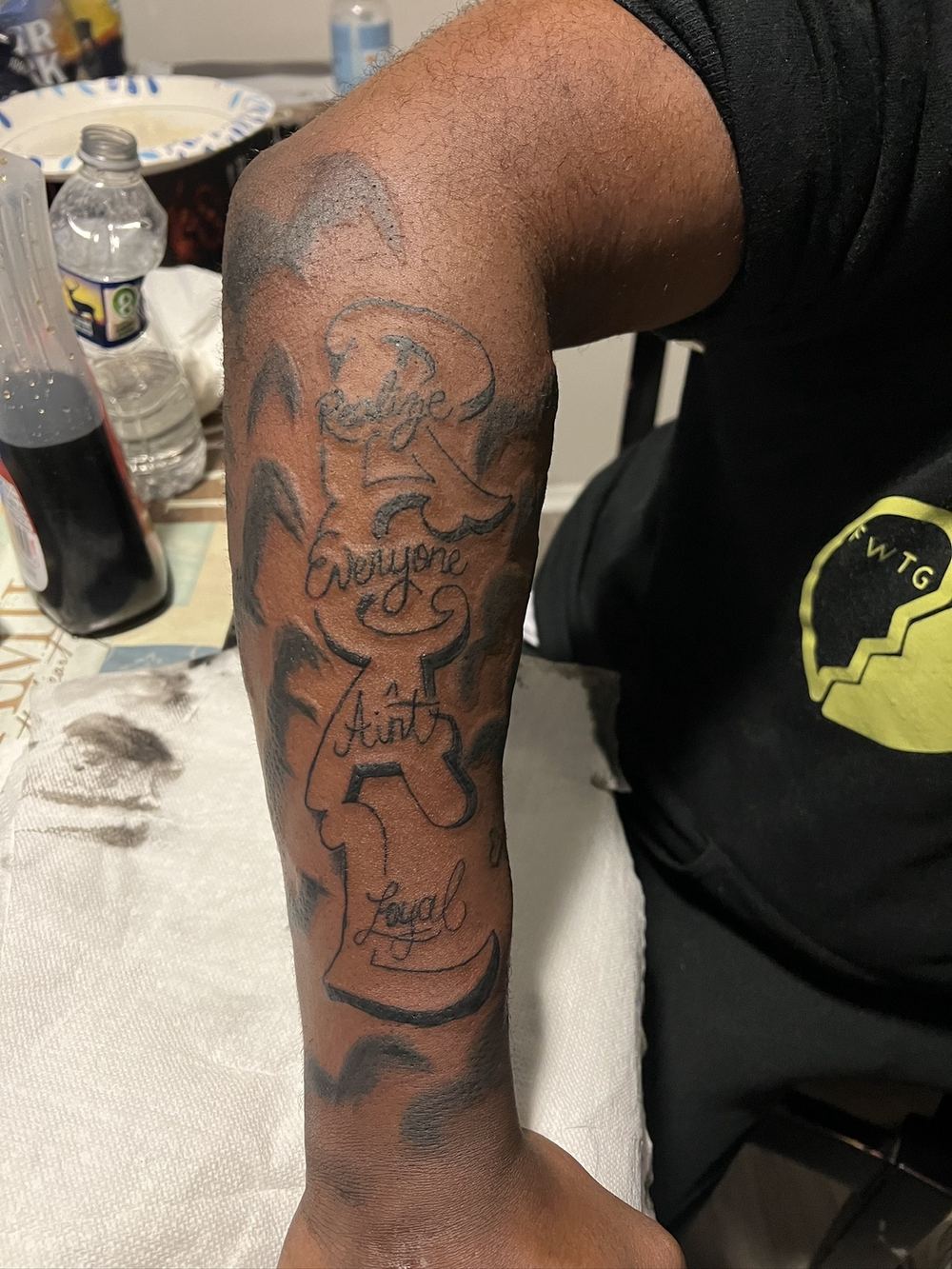 Everyone ain't loyal custom lettering forearm tattoo