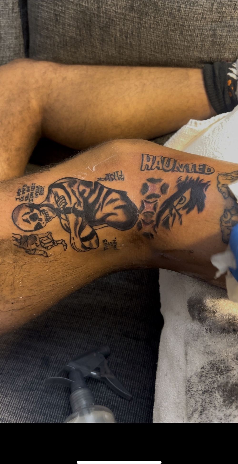 Haunted skull black and grey calf tattoo