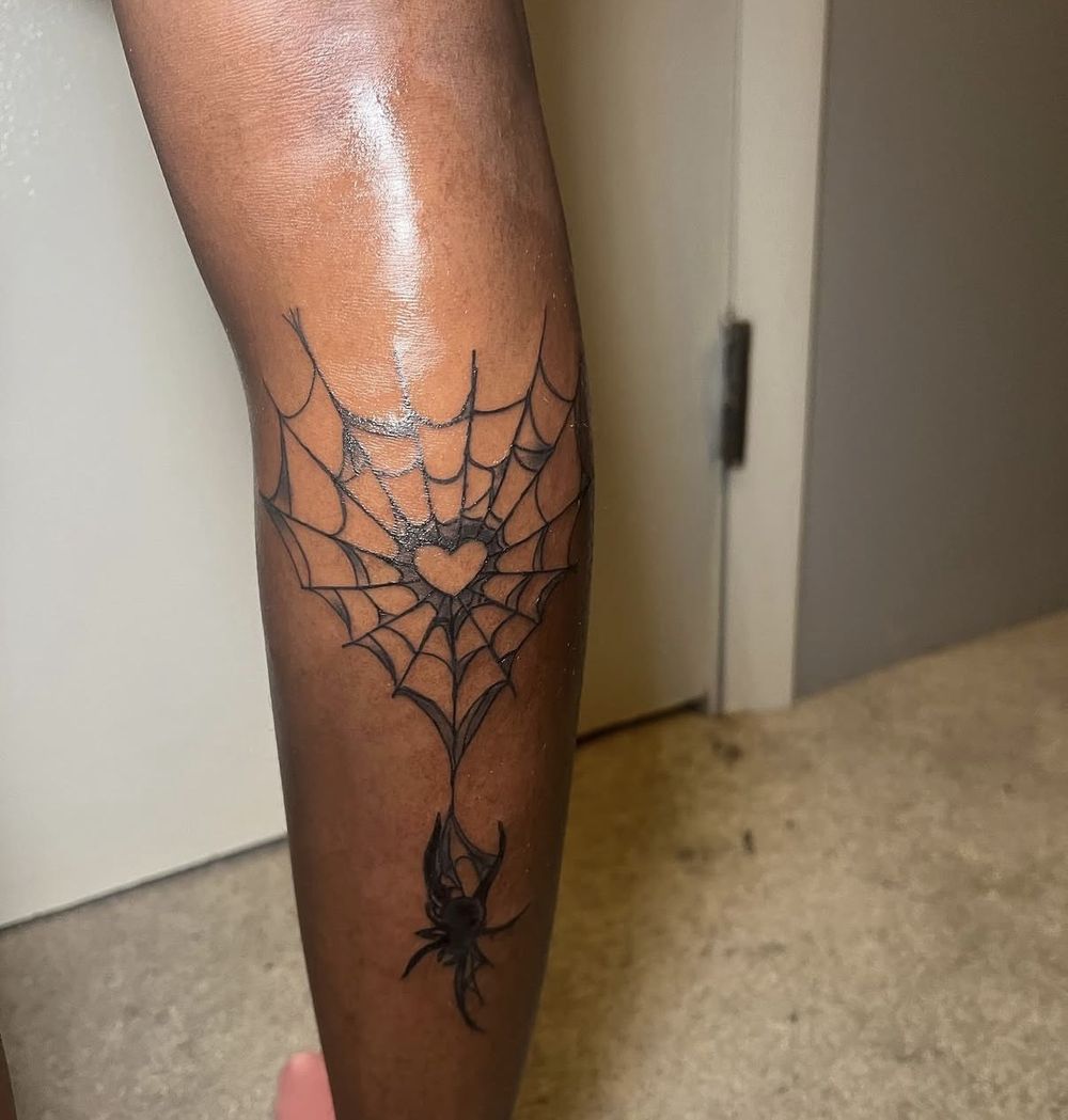 Spiderweb with heart and spider black and grey calf tattoo